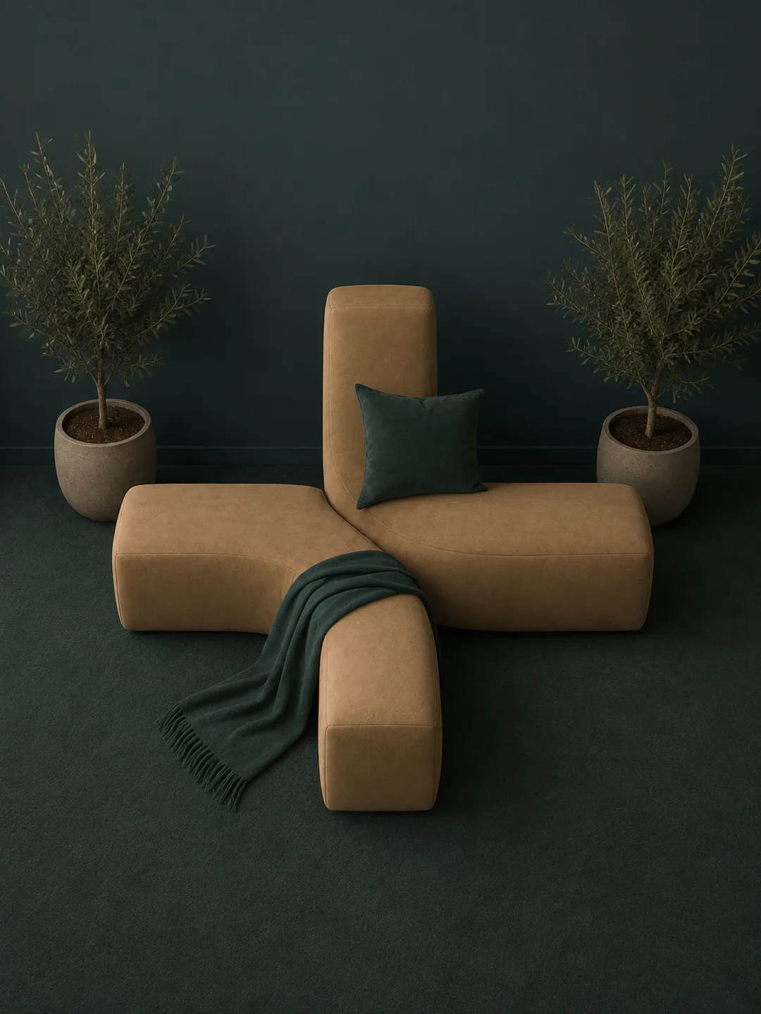 Plus-shaped camel sofa with a teal cushion and throw, flanked by two potted olive trees in a deep teal room